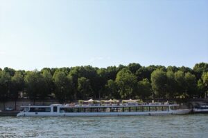 Paris Gourmet Dinner Seine River Cruise with Singer and DJ Set - The Diamant Bleu boat experience: rooftop views and indoor seating